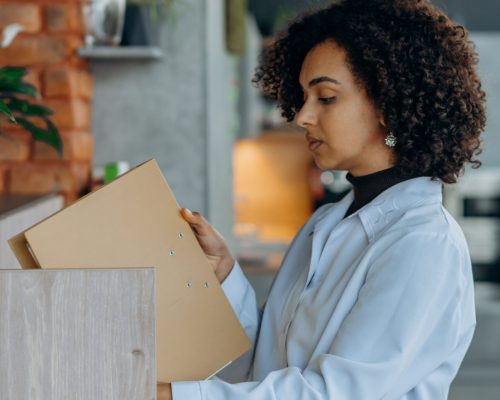 business woman putting away document into secured cabinet